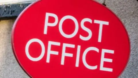 Red and white post office sign