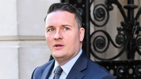 Wes Streeting, pictured wearing a dark blue suit and grey tie