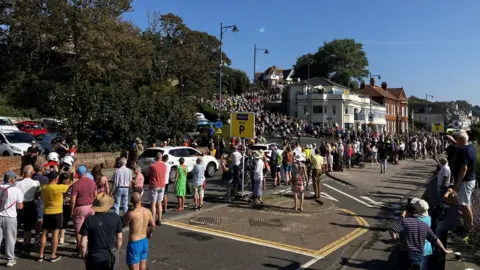 People line the streets to watch the Tour of Britain