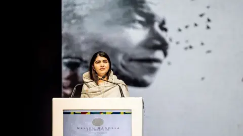 Roberta Ciuccio/AFP Nobel Peace Prize laureate Malala Yousafzai delivers the 21st Nelson Mandela Annual Lecture at the Johannesburg Theatre in Johannesburg on December 5, 2023. South Africa marks the 10th anniversary of the passing of Nelson Mandela with Pakistani education activist and Nobel Peace Prize laureate Malala Yousafzai delivering the 21st Nelson Mandela Annual Lecture.