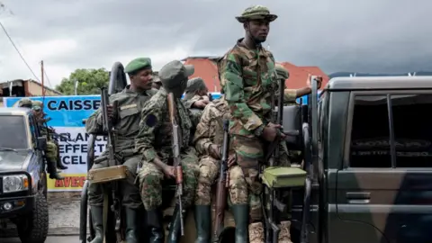 Members of the M23 rebel group mount their vehicles after the opening ceremony of Caisse Generale d'epargne du Congo in Goma, North Kivu province in the East of the Democratic Republic of Congo, April 7, 2025