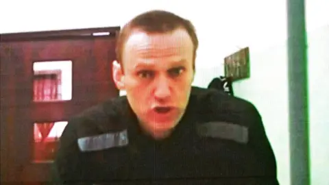 Getty Images Jailed Russian opposition figure Alexei Navalny appears on a screen via a video link from his penal colony during court hearings in Moscow, 22 June 2023