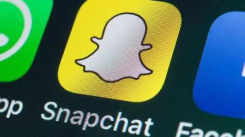 Getty Images The Snapchat app logo with the word snapchat written under it