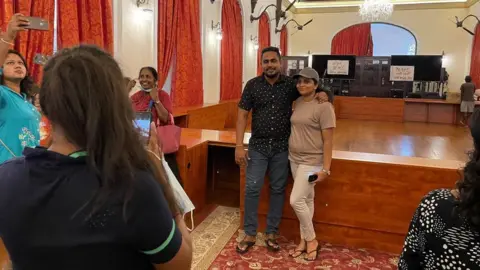 People pose inside the presidential residence in Colombo