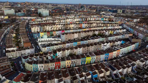An aerial photo of colourful houses in Totterdown, with other areas of Bristol in the background.
