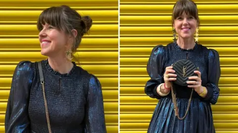 Caroline Jones In two images, Caroline wears a shiny dark blue metallic style dress with long puffed sleeves. Her dark brown hair is in a bun and she has a fringe. In the left hand picture she looks away from the camera and has a black YSL handnag over her shoulder. In the right hand picture she holds the back in front of her.