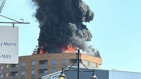 flames are seen on the top of a building