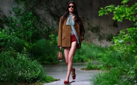 Reuters A model presents creations by Gucci at a fashion show in the Turbine Hall at Tate Modern, in London, Britain May 13, 2024. 