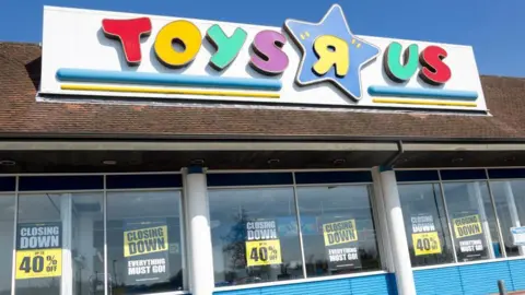 Getty Images A view of the Copdock Interchange Toys R Us store. The shop name is above the store in different colours. Closing down posters line the entirety of the windows of the store. 