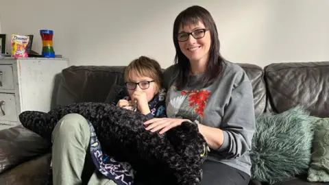 BBC Sam and Seb sat on a sofa at their home