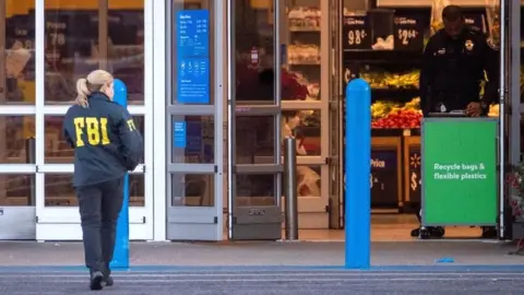 A member of the FBI works at the scene of the mass shooting