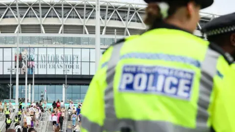 Getty Images A police officer stands outside Wembley Stadium before Taylor Swift's performance on August 15, 2024 in London