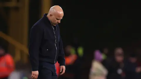 Arne Slot looks down in despondency