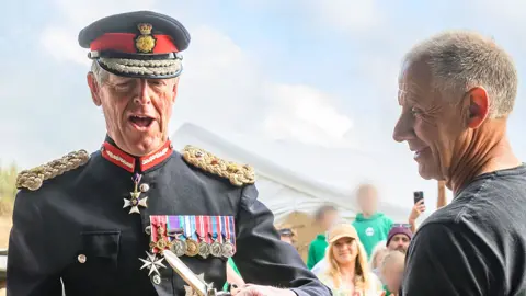 Holywell Bay Surf Life Saving Club A close up of Sir Edward. He is wearing his ceremonial clothing, and badges across his chest representing military service.