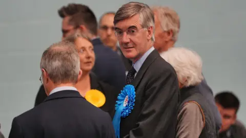 Sir Jacob Rees-Mogg leaves after losing his seat