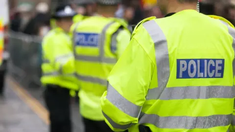 Getty Images Police in high-vis jackets doing crowd control