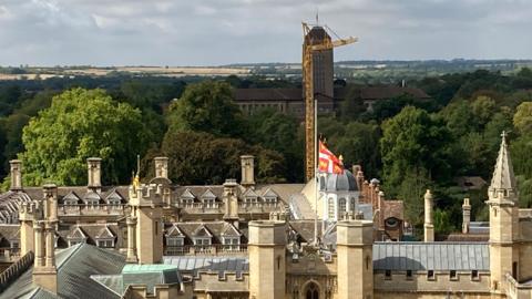 Cambridge skyline with University library, crane and fields in the background