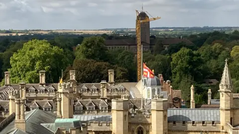 BBC Cambridge skyline with University library, crane and fields in the background