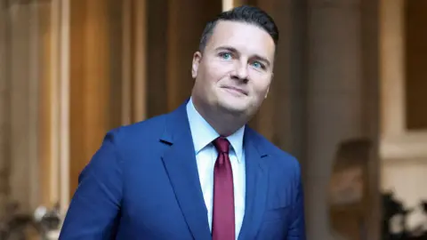 Reuters A head and shoulders crop of an image of Wes Streeting wearing a suit and tie looking off camera while on his way to attend the weekly cabinet meeting in Downing Street on Tuesday.