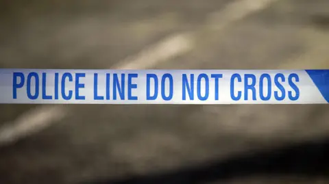 PA Media A stock image of police tape saying 'Police line, do not cross'