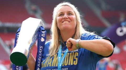 Chelsea manager Emma Hayes celebrates with the trophy after winning the 2023-24 WSL title