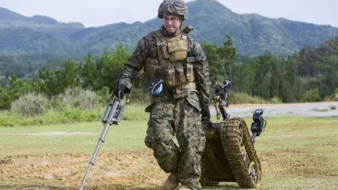 Getty Images Solider dragging a robot