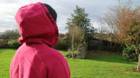 BBC Woman in a pink hoodie