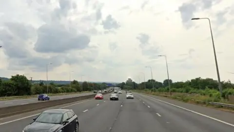 Google Maps: Vehicles travelling on the M5 near the grass verge. 