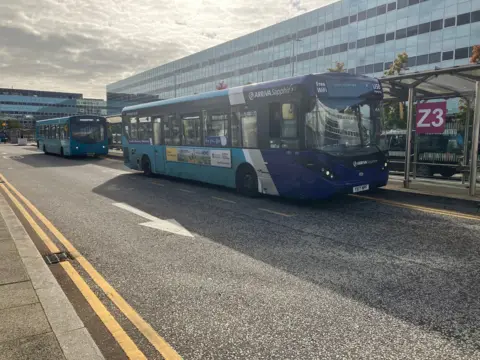 BBC/Amy Holmes Photograph of two Arriva buses parked one in front of the other near the station forecourt in Milton Keynes.