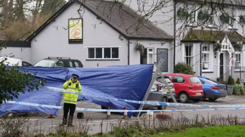 PA Media A police cordon at the Three Horseshoes pub in Knockholt, Kent, after police were called on Friday amid reports a woman had suffered serious injuries