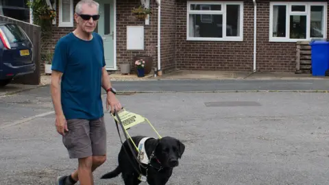 Jon Petty with his guide dog