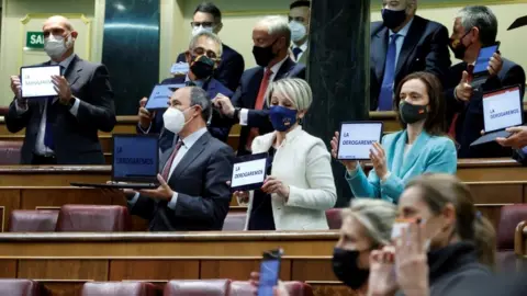 EPA Members of far-right party Vox display electronic devices reading "We will repeal it" after the vote of the law on euthanasia
