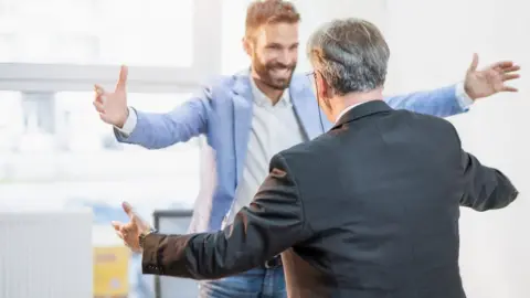 Getty Images Business colleagues hugging
