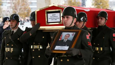 Getty Images Mourners carry the coffin of a Turkish soldier Halil Cankaya killed in an air strike in Syria's Idlib