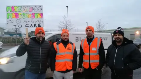 Local Democracy Reporting Service Umar Draz (far left) and Muhmmed Zeeshan (middle right) with two coworkers on the picket line
