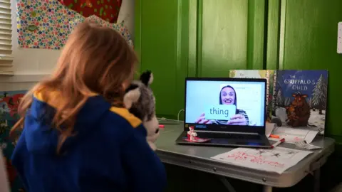 Gareth Copley Schoolgirl takes part in an English lesson from home