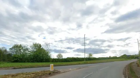 A generic image of the A53 pictured at a roundabout junction, where one of the exits, not seen on this photo, is signposted Hodnet.