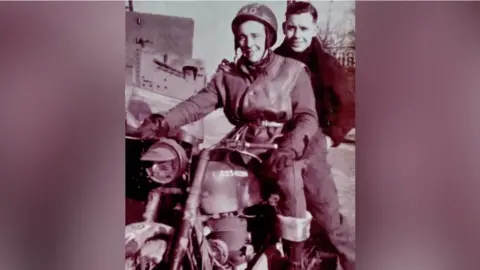 Family photo An old black and white photo from World War Two with Don riding a motorbike with a man, both smiling