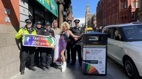 Merseyside Police Representatives from the Liverpool City Centre Neighbourhood Policing Team, LCR Pride Foundation CEO Andi Herring, Liverpool drag queen Lady Sian, Liverpool City Centre Inspector Jack Woodward and Sergeant Craig Winstanley from Merseyside Police, at the new Rainbow Taxi Rank.