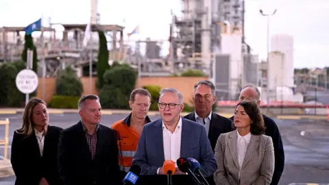Getty Images Australia's Prime Minister Anthony Albanese (C) speaks during a press conference after a visit to the Geelong Oil Refinery which was damaged by fire
