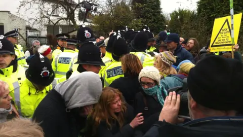 A crowd of police enmeshed with protestors