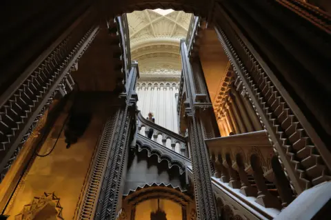 National Trust/John Millar a large staircase with gothic elements throughouht 