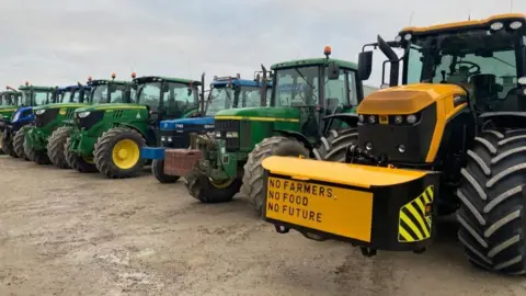 Louise Fewster/BBC Tractors lined up in a field