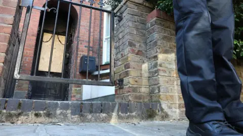 Police officers stand outside Britain's Prime Minister Keir Starmer's private home, after it was damaged by fire in a suspected arson attack in north London