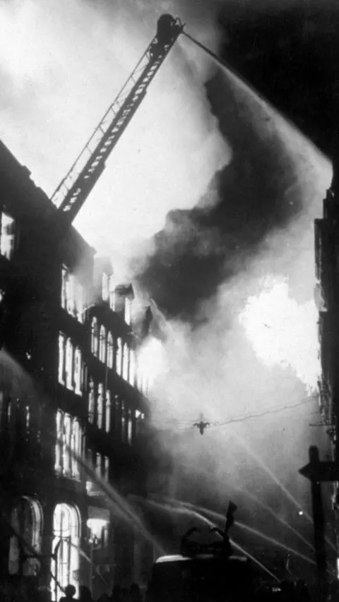 PA Media Firefighters tackle buildings bombed during the Blitz in London