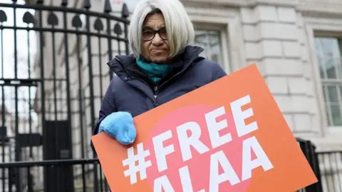 File photo showing Laila Soueif, mother of jailed Egyptian-British activist Alaa Abd el-Fattah, holding a poster calling for his release outside Downing Street in London (20 January 2025)