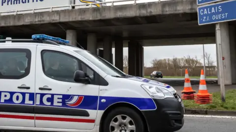 Police officers sit in parked car near the French border in Calais, France, on Monday, 18 March 2019