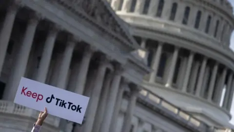 A person holds a sign during a press conference about their opposition to a TikTok ban on Capitol Hill in Washington, DC on March 22, 2023.