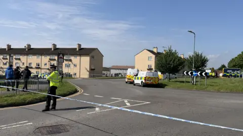 Emergency services staff and vehicles on Aberthaw Road. 