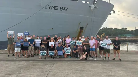 Royal Fleet Auxiliary seafarers on strike. Stood with RMT posters next to RFA Lyme Bay